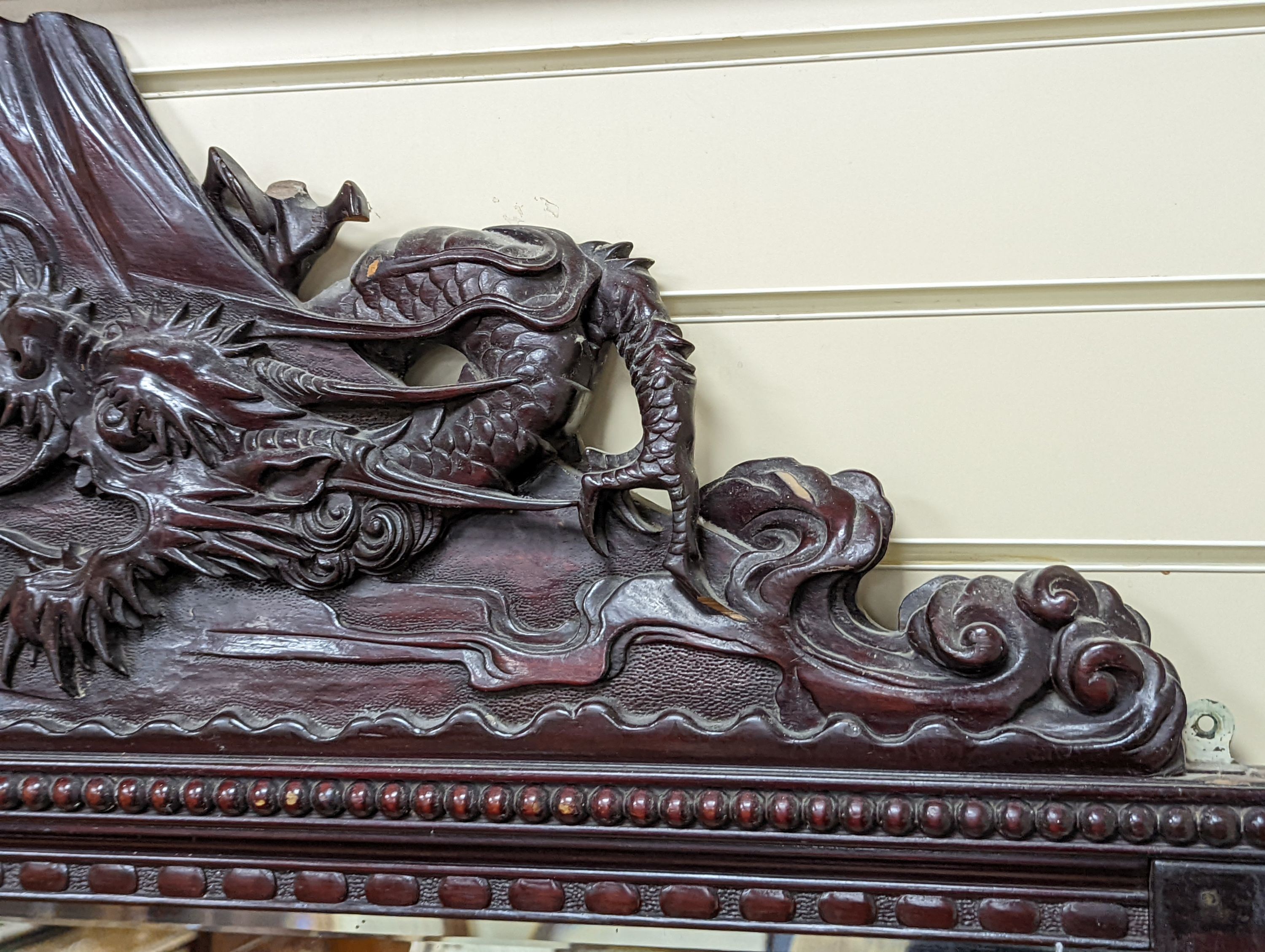 A Japanese carved hardwood dragon overmantel mirror, width 112cm, height 180cm